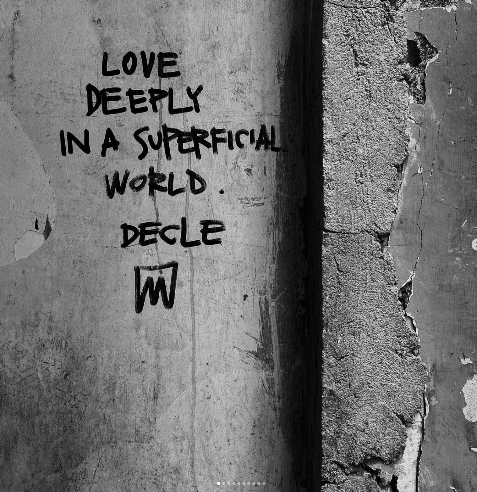 Handwritten message about love on a weathered concrete wall